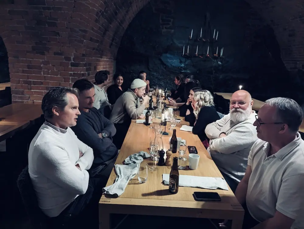 Netler consultants socializing around a table