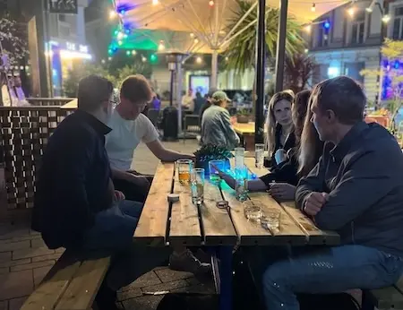 Netler consultants socializing around a table